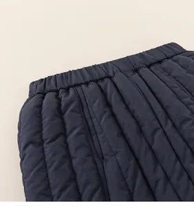 Detail of elastic waistband on dark blue quilted winter trousers with windproof fabric