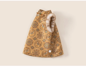 Detail of golden brocade kids vest with traditional horse pattern and faux fur trim