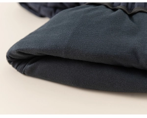 Detailed macro view of winter kids' thick padded trousers showing warm fabric texture