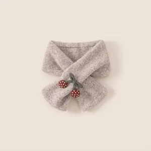 Thick knitted girl's scarf in oatmeal with green bow and red cherry accents for winter