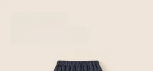 Detail of kids navy blue quilted trousers with elastic waistband and vertical stripes