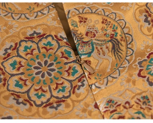 Close-up of champagne gold brocade fabric with detailed jacquard and hidden zipper