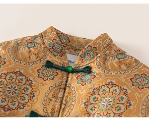 Detail of Chinese style mandarin collar with green frog button and gold floral jacquard