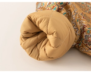 Macro detail of quilted lining and floral brocade fabric on Chinese winter coat