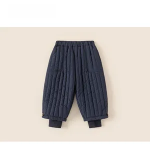 Detail of dark blue quilted thermal trousers for children with elastic waist and ribbed cuffs