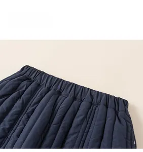 Detail view of navy blue quilted winter trousers with comfortable elastic waistband