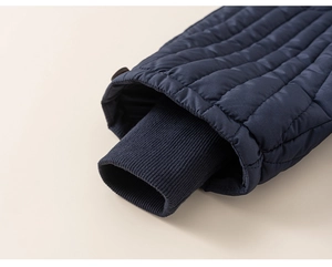 Detail of navy blue quilted winter trousers featuring windproof ribbed elastic cuffs
