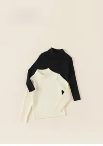 Close-up of kids' ribbed knit turtleneck tops in black and cream white for winter