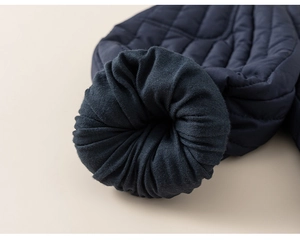 Close-up of navy blue quilted cotton pants with elastic ribbed cuff for kids warmth