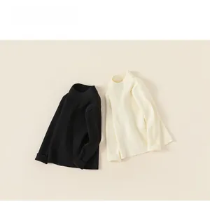 Detail of ribbed knit texture and turtleneck collar on black and beige sweaters