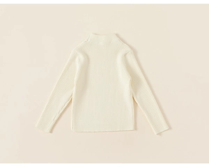Detail shot of girls' cream white ribbed knit sweater showing soft texture and high neck