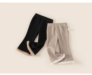 Detail of children's ribbed knit flare pants with fluffy faux fur trim at the leg openings