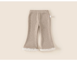 Detailed view of beige knitted girls bell bottom trousers with white faux fur trim cuffs