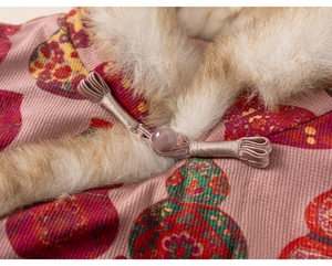 Detailed view of pink corduroy girls vest with traditional knot and warm fur collar