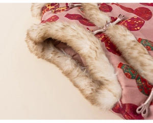 Detail of pink floral fabric with red gourd patterns, faux fur trim, and Chinese frog button