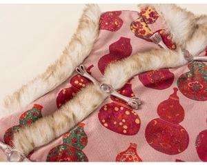 Detail of pink Chinese festive vest featuring traditional gourd prints and plush faux fur trim