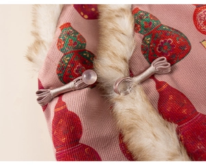 Detail of traditional Chinese frog button and faux fur trim on pink floral winter vest