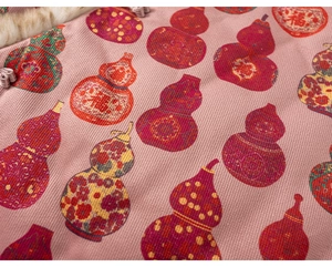 Detailed macro view of pink floral fabric with lucky gourd patterns and fur collar trim