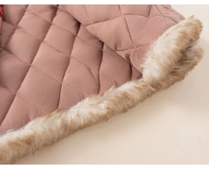 Macro detail of girls winter vest showing pink quilted fabric and soft faux fur lining