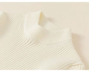 Detail of cream white ribbed knit fabric and stand collar on children's winter vest
