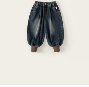 Detail view of dark blue washed denim joggers for boys with brown ribbed ankle cuffs