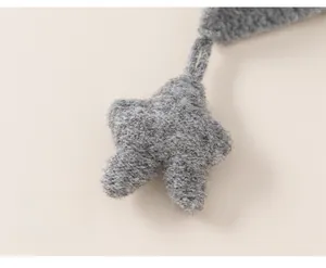 Close-up of a 3D grey knitted star accessory showing soft wool texture and craftsmanship