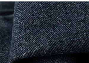 Macro shot of high-quality navy blue denim fabric showing detailed twill weave texture