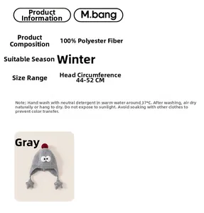 Detail view of grey knit baby winter hat with red pompom and star earflap accents