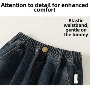 Detail view of boys denim jeans showing elastic waistband and vintage copper button