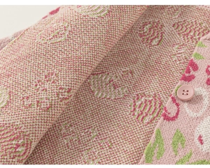 Detail der rosa Strickjacke mit Erdbeer-Jacquard-Muster und passenden Harzknöpfen