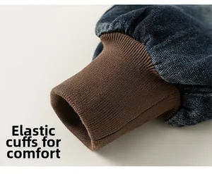 Detailed view of kids denim pants featuring retro washed texture and brown cuffed design