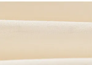 Close-up of soft beige tulle fabric texture and high-quality stitched edges of girl's dress