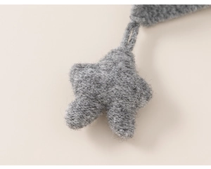 Detailed view of a grey wool star pendant showing its thick texture and fuzzy fiber finish