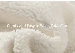 Close-up of soft white sherpa fleece fabric showing thick curly texture for winter warmth