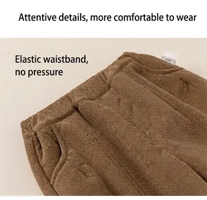 Detail view of brown corduroy trousers showing the elastic waistband and side pockets