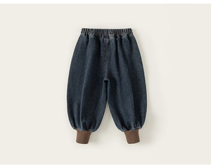 Detail view of boys denim joggers with brown ribbed cuffs and elastic waistband