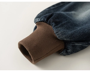 Close-up of boys' denim pants showing ribbed elastic cuffs and stitching detail