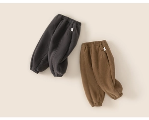Detail of thick winter thermal trousers with elastic waist and ribbed cuffs for kids