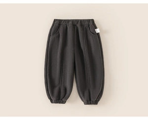 Detail of dark grey quilted toddler joggers with elastic waist and ribbed ankle cuffs