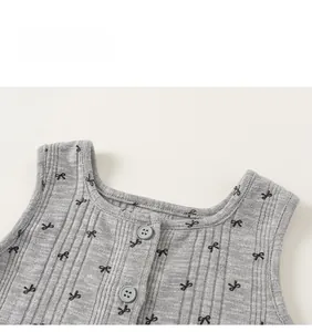 Détail de l'encolure d'un gilet en tricot pour bébé avec boutons et petits nœuds