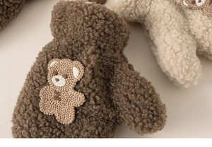 Close-up of thick sherpa fleece texture and cute teddy bear embroidery on kids gloves