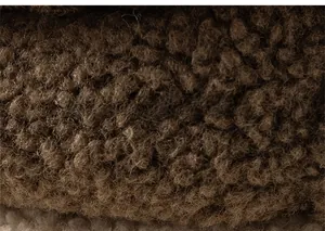 Detailed close-up of thick brown sherpa fleece fabric showing soft and warm texture