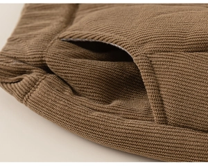 Detail of boys' brown corduroy trousers showing elastic waistband and side pocket sewing