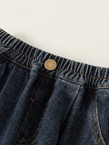 Fashionable boys dark blue denim joggers with elastic waist and metal button detail