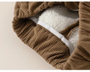 Close-up of boys thick brown corduroy pants with warm white fleece lining and elastic cuff