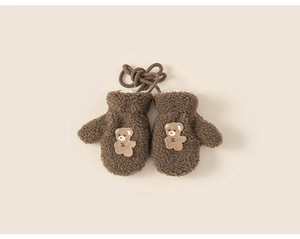 Detail of warm brown plush mittens for kids featuring a cute cartoon bear patch and cord