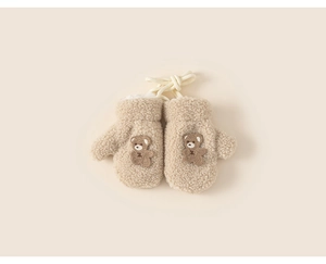 Close-up of beige plush toddler mittens with cute brown bear embroidery and lanyard