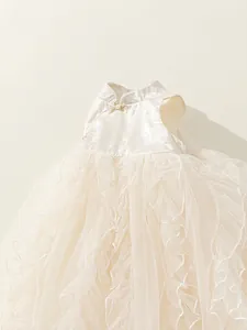 Sleeveless cream tulle princess dress with Chinese style collar and gold bow detail