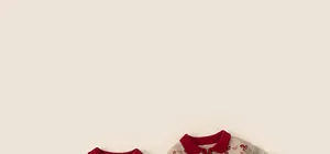 Close-up of beige knit cardigan with red collar and cute bow details for girls