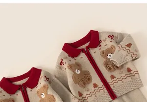 Close-up of knit toddler cardigan with cartoon bear jacquard and red collar detail